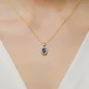 Złota zawieszka z topazem London Blue 0,50ct i brylantami 0,08ct Z0574