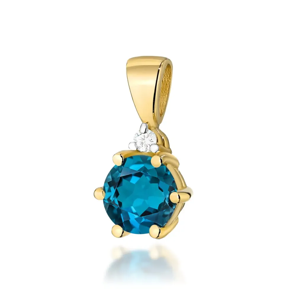 Złota zawieszka z topazem london blue 0,50ct i brylantem 0,015ct Z076